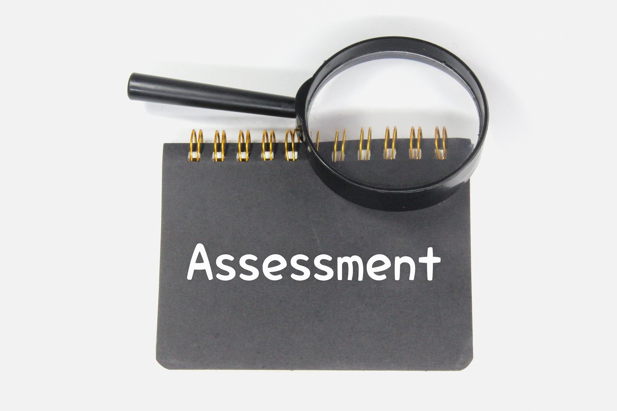 magnifying-glass-notebook-and-word-assessment-2022-11-02-17-55-45-utc