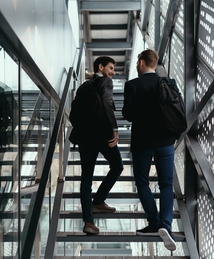 two-men-going-up-down-stairs-while-chatting_158595-5390